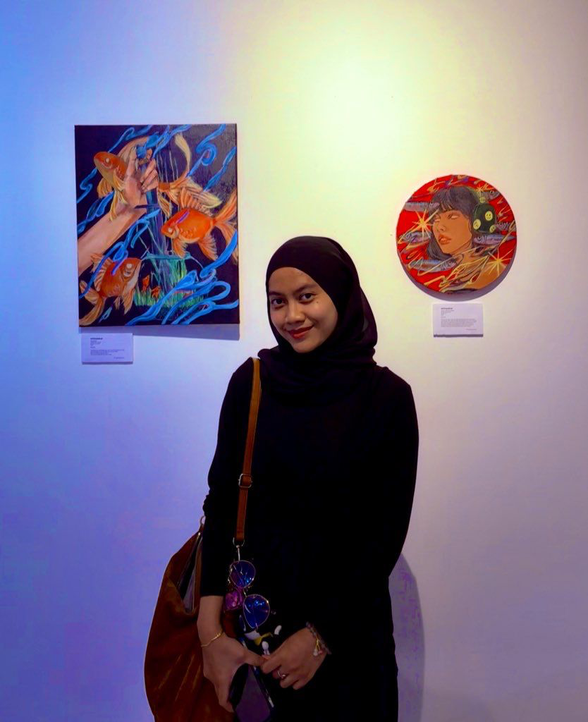 whiteyedcat standing beside displayed artwork at Visitors Only GrimDreamStudio 2025.